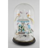 A Victorian lampwork sculpture under a glass dome, modelled as various exotic birds drinking from