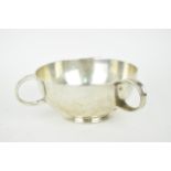 An Arts and Crafts style three handled silver bowl by William Hutton & Sons, Birmingham 1919, of