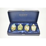 A cased set of Moorcroft pottery small posy vases, in various floral patterns, dated 2000,