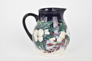 A Moorcroft pottery 'Snowberry' jug, designed by Nicola Slaney, 2002, with tublined decoration on
