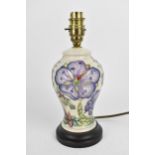 A Moorcroft pottery 'Meadow Cranesbill' pattern lamp designed by Phillip Gibson, the baluster body