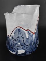 Siddy Langley (b.1955) British, a studio glass freeform vase with uneven frill rim and rounded base,