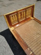 An Egyptian Revival chaise longue, the mahogany frame with gilt carved panels depicting relief