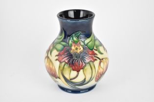 A Moorcroft pottery 'Anne Lily' baluster vase, designed by Nicola Slaney, with tubelined floral