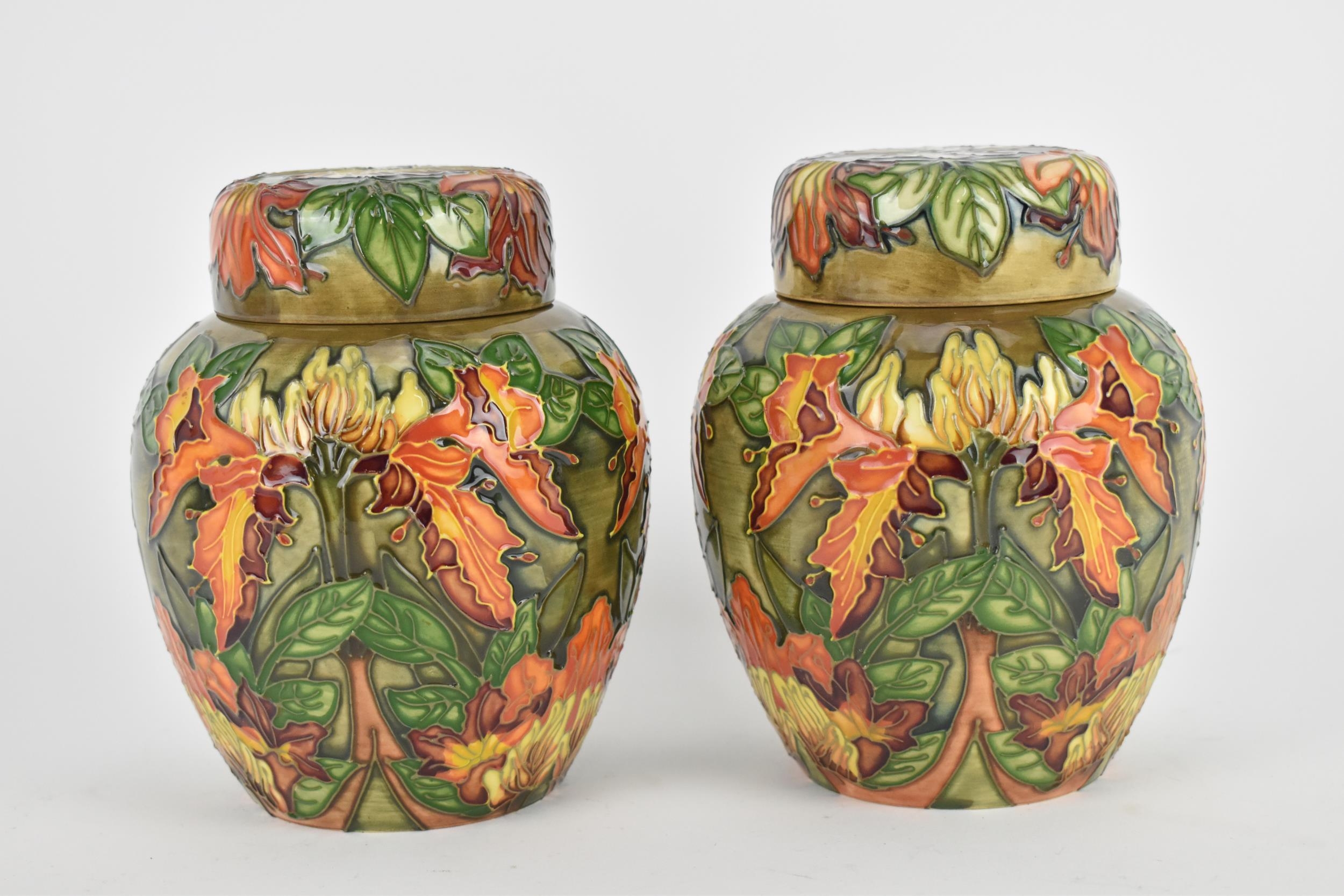 A pair of Moorcroft lidded ginger jars designed by Philip Gibson, in the 'Flame of the Forest'