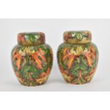 A pair of Moorcroft lidded ginger jars designed by Philip Gibson, in the 'Flame of the Forest'