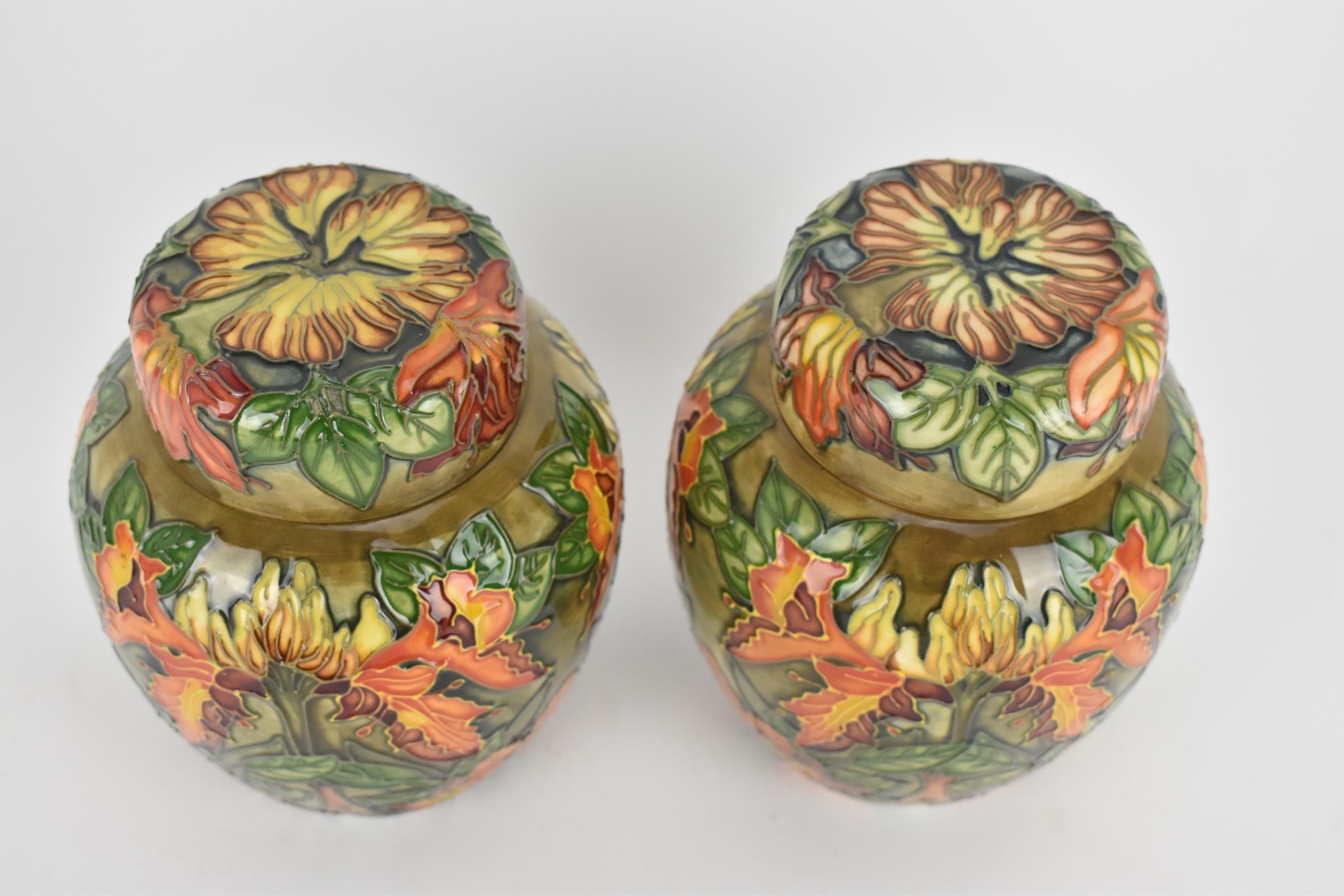 A pair of Moorcroft lidded ginger jars designed by Philip Gibson, in the 'Flame of the Forest' - Image 2 of 4