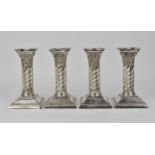 A set of four George III style silver plated candlesticks by Joseph Rodgers & Sons, the twist fluted