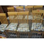A set of 8 Contemporary beech slat back kitchen chairs with Retro style cushioned seats on square