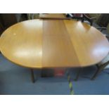 A mid-century retro D-end extending dining table with single butterfly wing rising leaf, on shaped