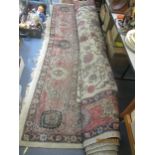 A large hand woven carpet with floral decoration and triple guard border 280cm x