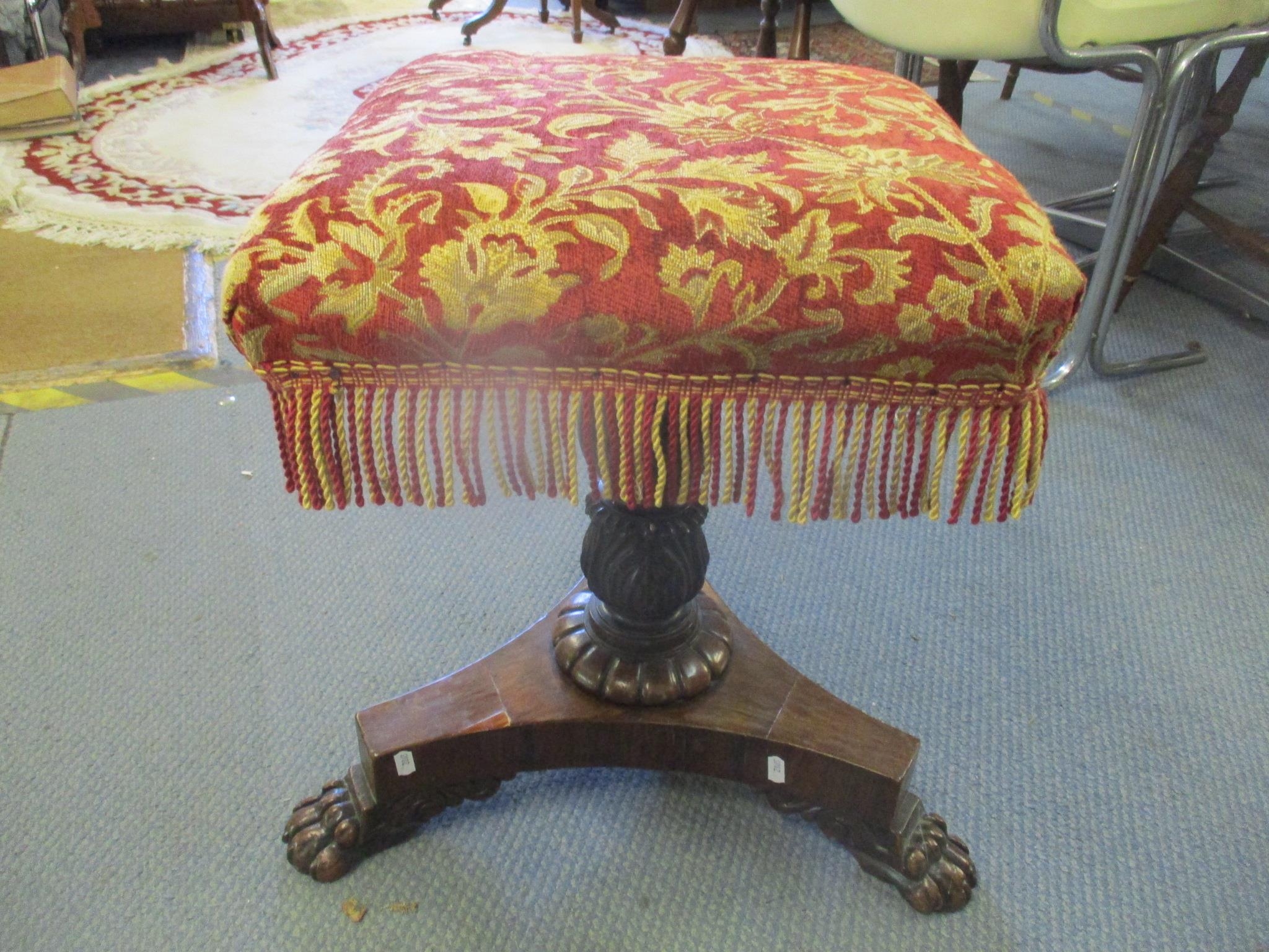 A 19th century rosewood swivel topped piano stool on three lion paw feet Location:SR