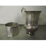 An early 20th century silver napkin ring, together with a white metal thistle engraved cup 88.2g