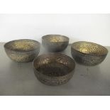 Four white metal bowls having a gadrooned rim above a floral design, 171.9 Location: