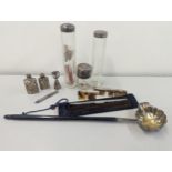 A mixed lot of silver items to include silver lidded dressing table bottles, combe, toddy ladle