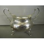 An early 20th century silver sugar bowl raised on four claw feet, Walker and Hall, hallmarked