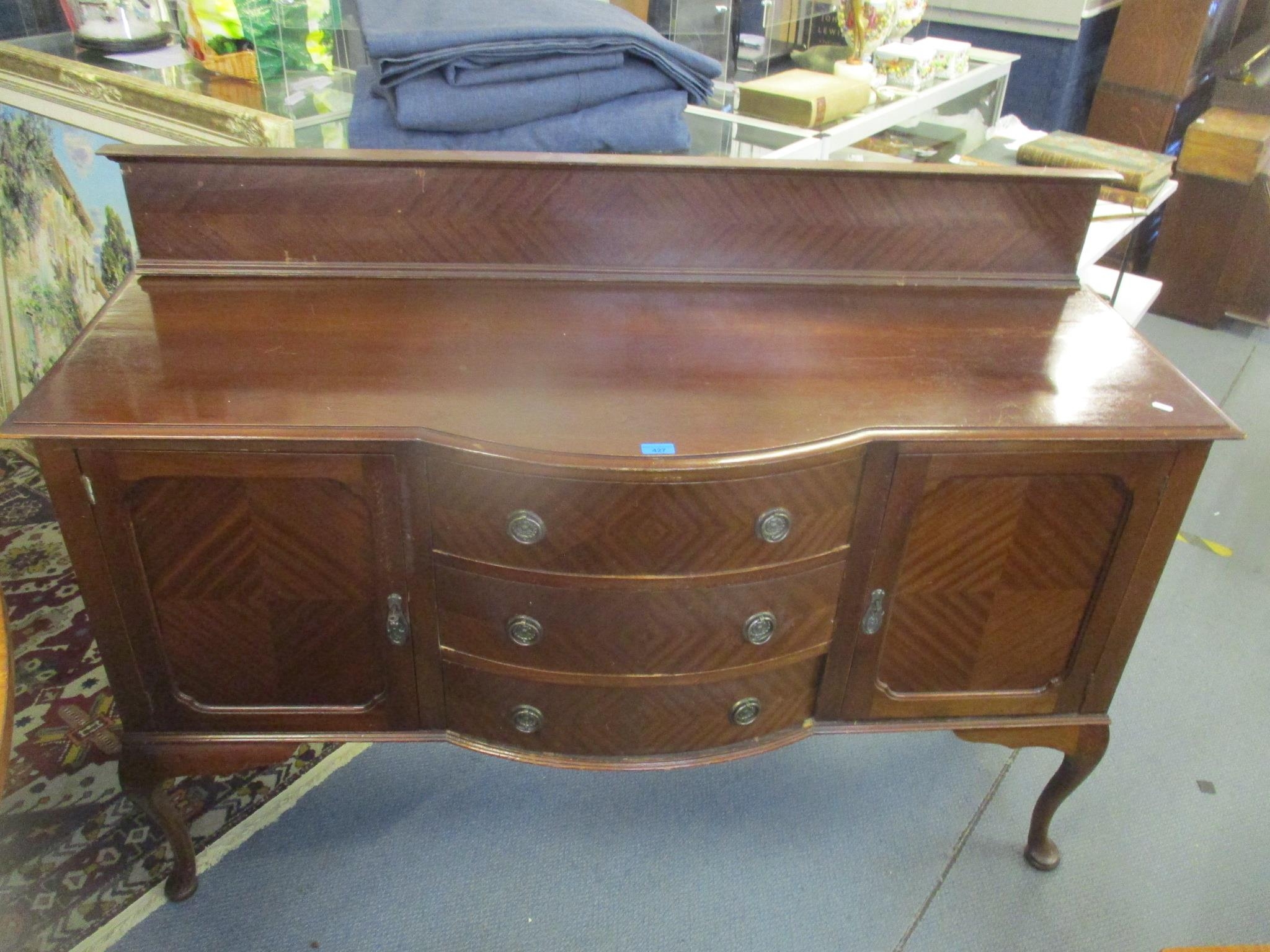 A reproduction mahogany sideboard having a raised back and on cabriole legs 110cm h x 152cm w