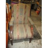 An early 20th century Georgian style upholstered open armchair, on square fluted legs united by