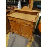 A Victorian pine side cabinet having a raised back with two drawers and cupboards below Location: