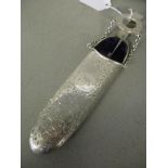An early 20th century silver glasses case with belt attachment, the case having a scroll design,