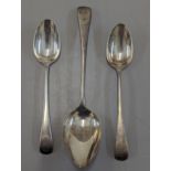 A group of three George III silver spoons to include a pair of tablespoons, and one larger example