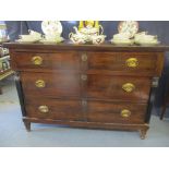 A 19th century French three drawer commode having graduated drawers, lacquered pillars and tapered