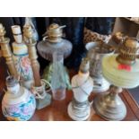 A group of 20th century table and oil lamps to include Poole together with two Art Deco glass