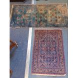 A red ground prayer rug and a Nils Nessim Antik Pao-Tou blue ground rug with Chinese symbols,