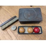 A set of 20th century three billiards balls, a brush and tips contained in a collared Bowser tin
