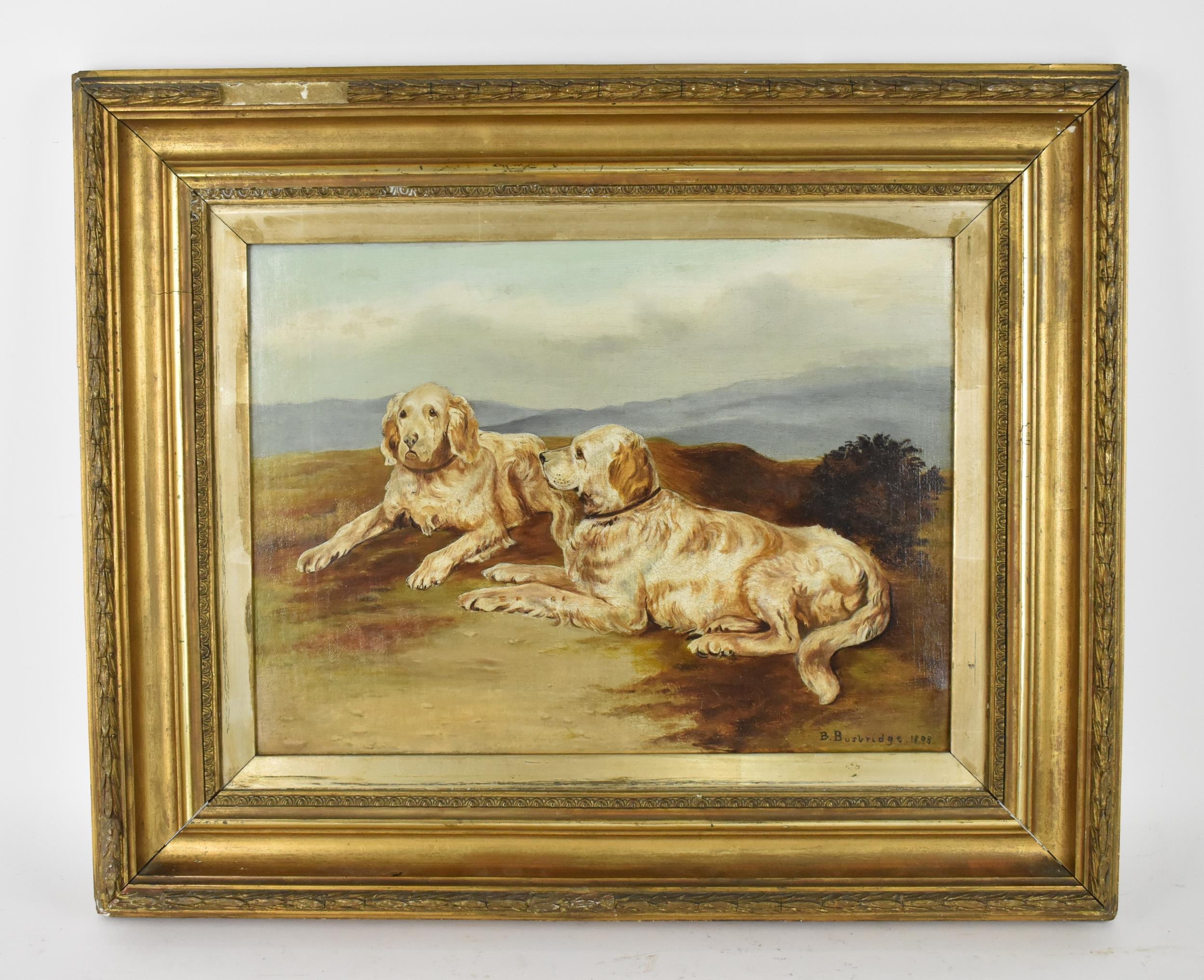 British School, late 19th century depicting two golden retrievers lying in a naturalistic setting,