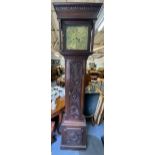 A Georgian oak cased longcase clock, the heavily carved case having turned columns flanking the