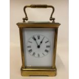 A 19th century French Richard & Cie brass carriage clock having a white enamel dial, Roman