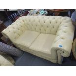 A pair of cream leather upholstered button back chesterfield sofas Location: