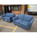 A pair of modern blue upholstered two person sofas Location: red