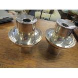 Pair of white metal designer candlesticks, marks to base edge, looks to read 'silver EMA' Location: