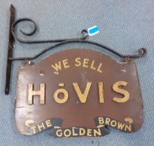 A vintage wooden Hovis bread shop sign in a wrought iron frame together with a group of wrought iron