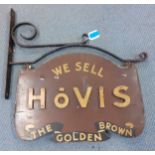 A vintage wooden Hovis bread shop sign in a wrought iron frame together with a group of wrought iron