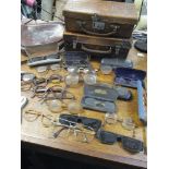 A collection and antique and vintage spectacles and sunglasses, two small leather cases, and a