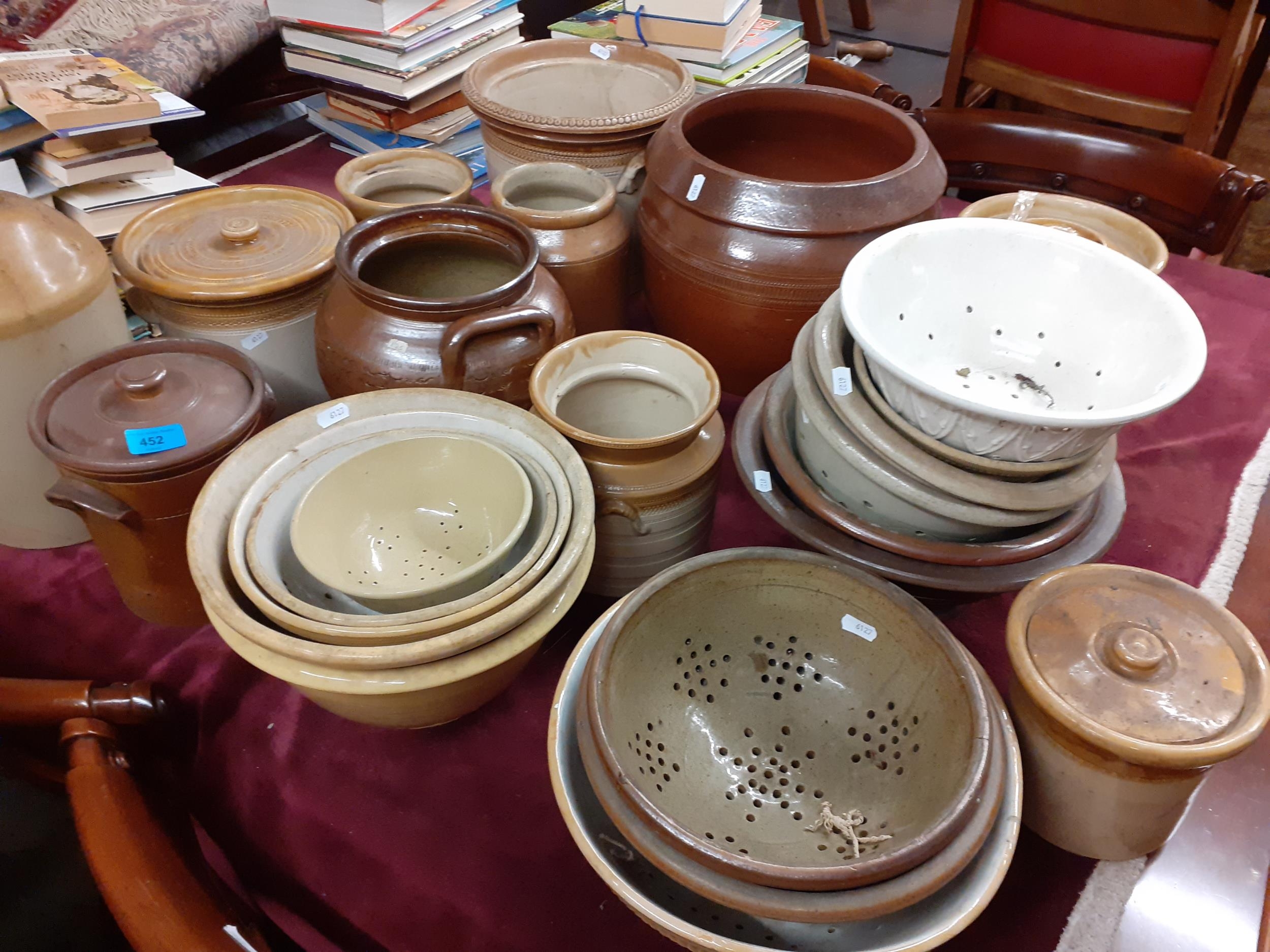 A quantity of early 20th century kitchen stoneware storage jars, sieves and bowls Location: G