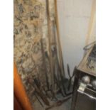 A group of garden tools to include a wooden handled fork, loppers, hoes, rake and others Location: