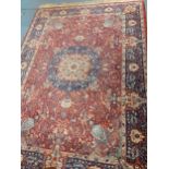 A machine made and red ground rug, 250cm x 170cm, Location: G