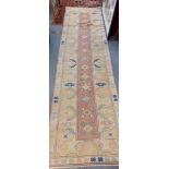 A hand woven runner having a yellow ground and tasselled ends, 267cm x 73cm Location: