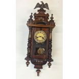 A mahogany cased Vienna style wall clock having Roman numerals and Eagle finial Location:
