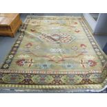 A Belgian machine woven rug having a central motif and tasselled ends, 345cm x 248cm Location: