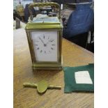 An early 20th century brass cased fire window, repeating carriage clock, with moon hands, white