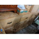 A Pine dresser base having three drawers above four cupboards Location: G