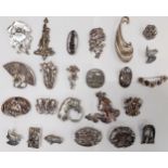 A collection of pewter and silver coloured Modernist and Art Nouveau style brooches to include the
