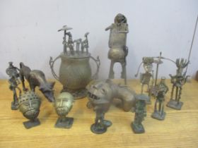 A group of African Ashanti brass figures, mask busts, gold dust 'bronze' pot and cover, and animal