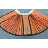 A 19th Century Chinese skirt, late Qing Dynasty, in orange silk (mamianqun), two panels of