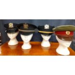 Four Worldwide police hats comprising an NYPD police officer's cap made by Tanen Uniform Cap Co, NY,